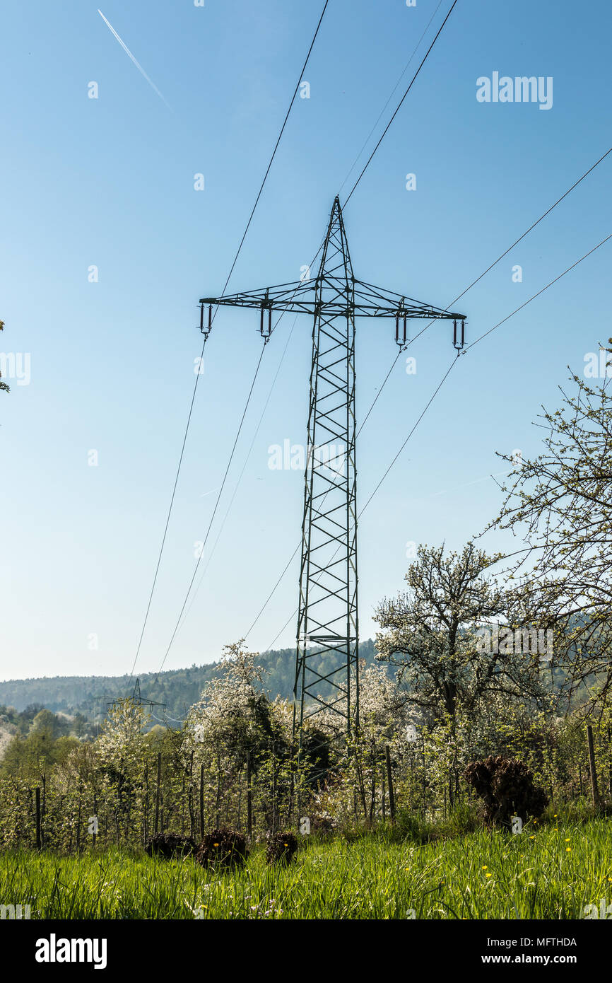 Power pylon on the green field Stock Photo