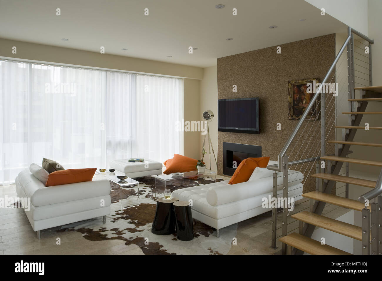 Sofa Facing Wall Mounted Television Above Fireplace In Modern