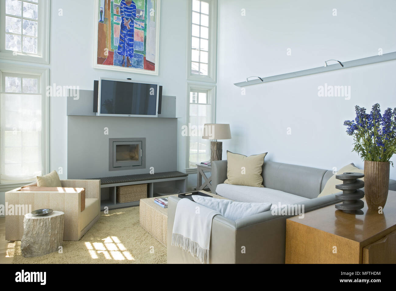 Sofa facing wall mounted television in modern sitting room Stock Photo Alamy