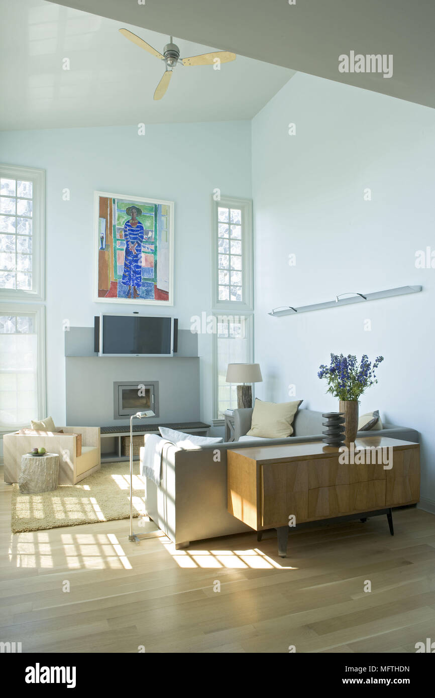 Sofa facing wall mounted television in modern sitting room Stock Photo Alamy