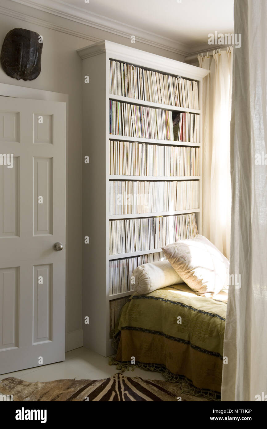 View Past Curtains To Built In Shelving Behind Single Bed Stock