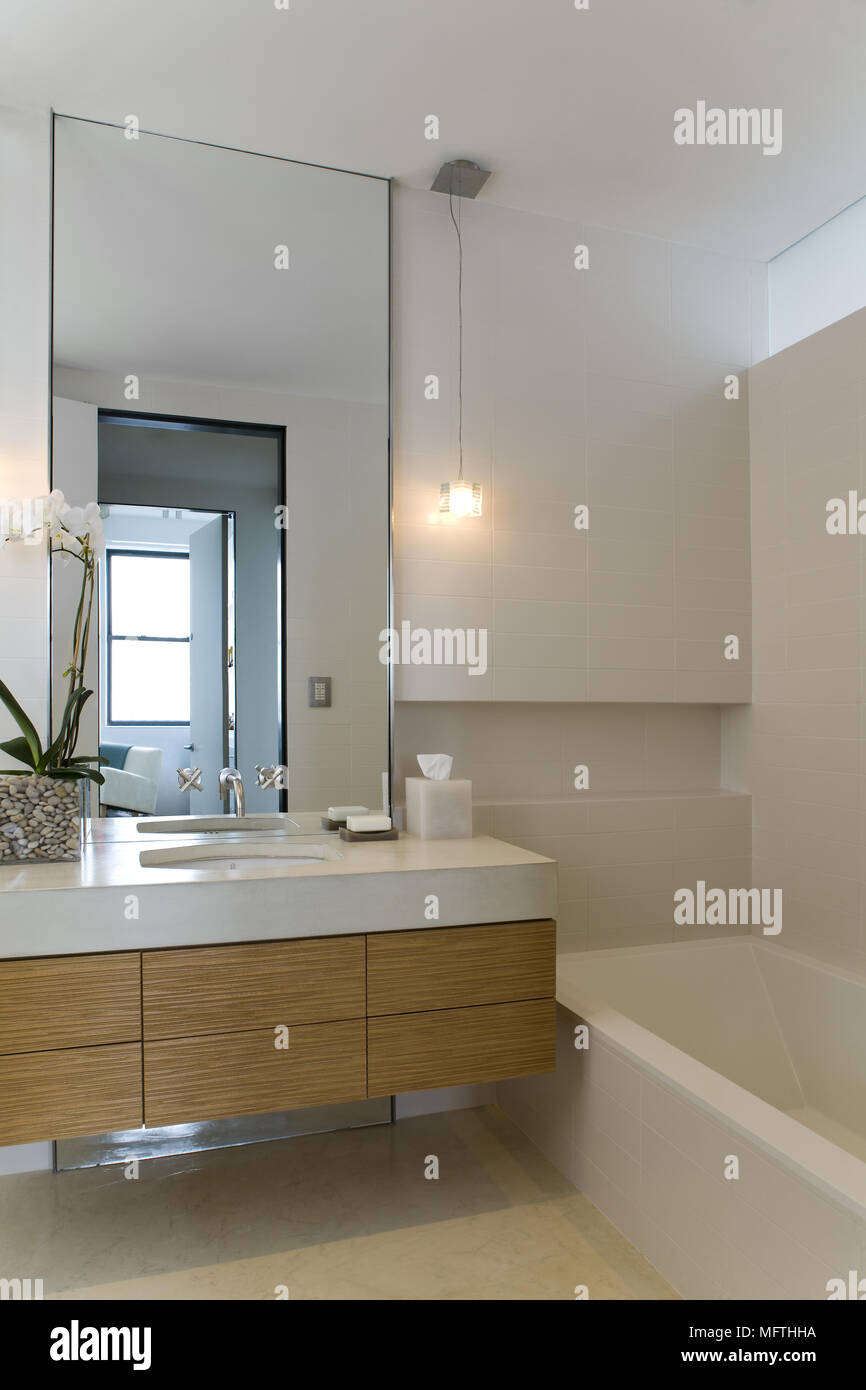 Washbasin set in drawer unit next to bathtub in modern bathroom Stock ...