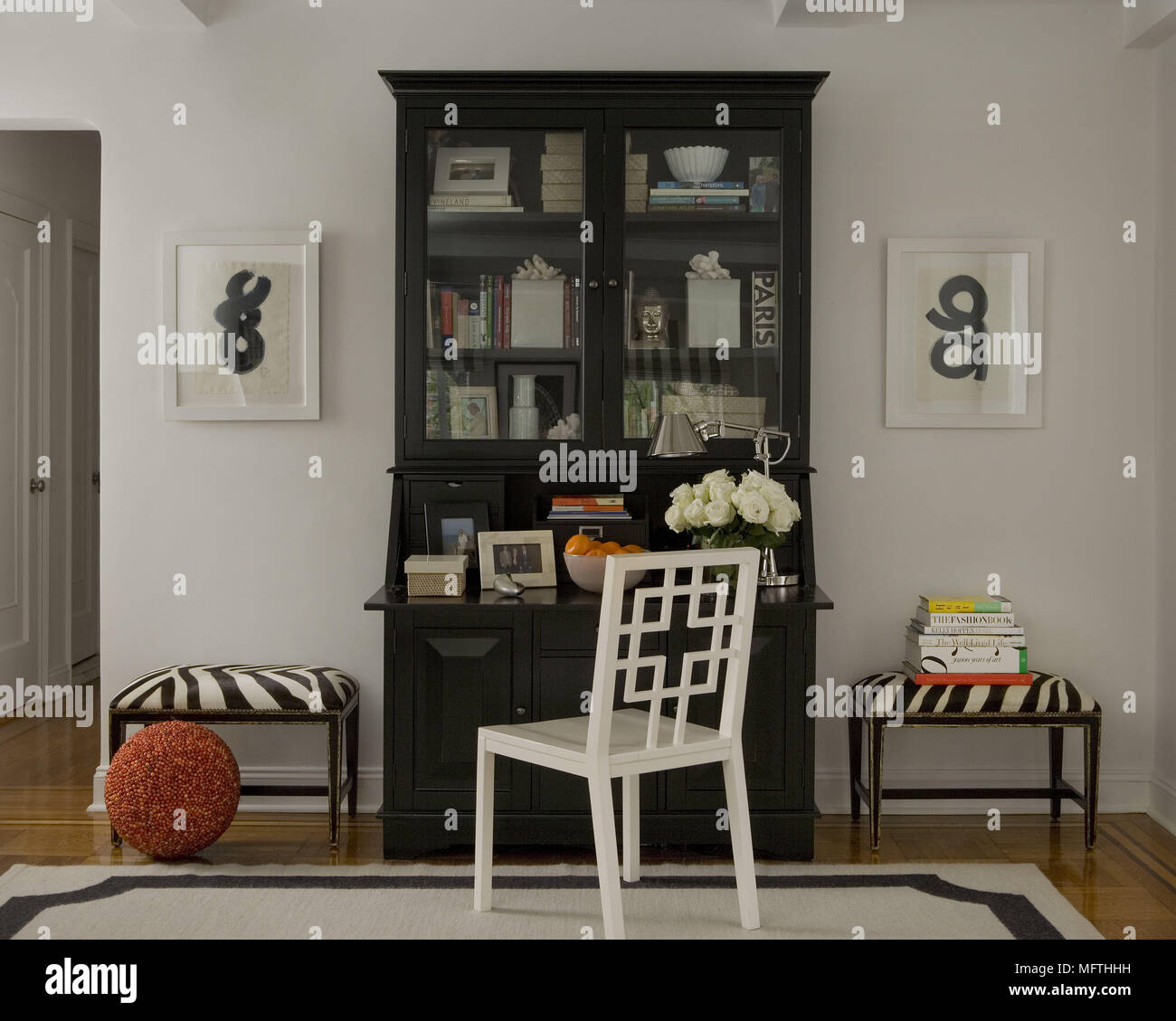 White wood chair in front of bookcase writing desk in traditional style