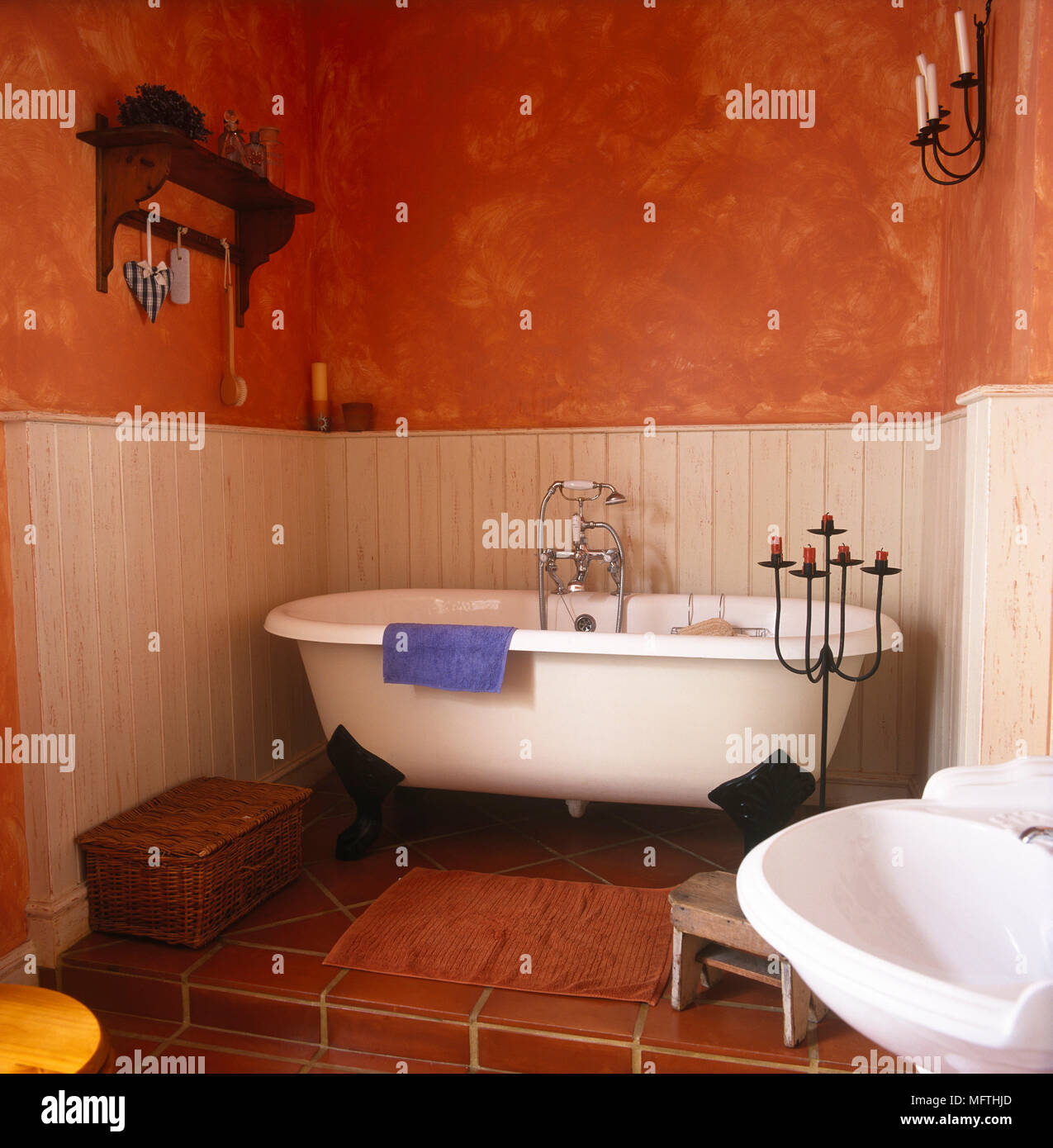 Free standing roll top bath in terracotta bathroom Stock Photo