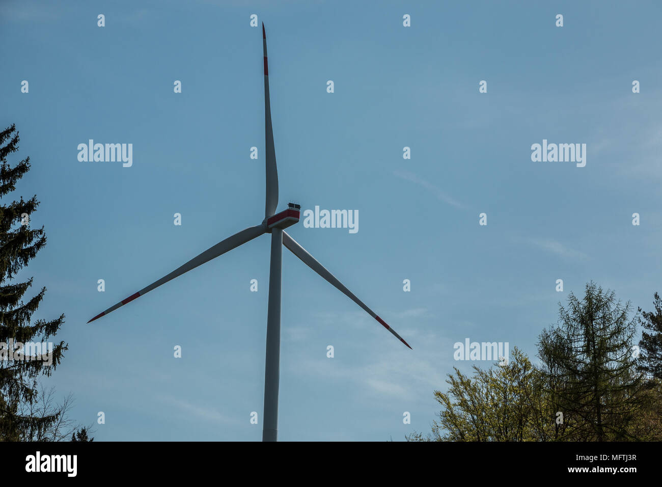 Big windmills for wind power near the village Stock Photo Alamy