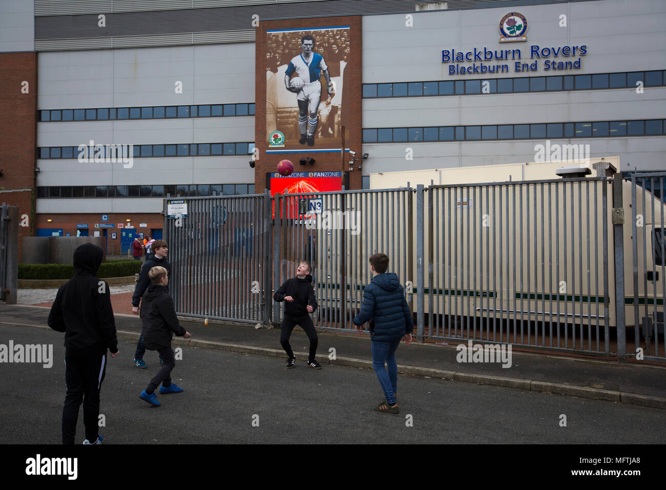 A group of young boys playing football at the back of the Blackburn End Stand before Blackburn Rovers played Shrewsbury Town in a Sky Bet League One fixture at Ewood Park. Both team were in the top three in the division at the start of the game. Blackburn won the match by 3 goals to 1, watched by a crowd of 13,579. Stock Photo