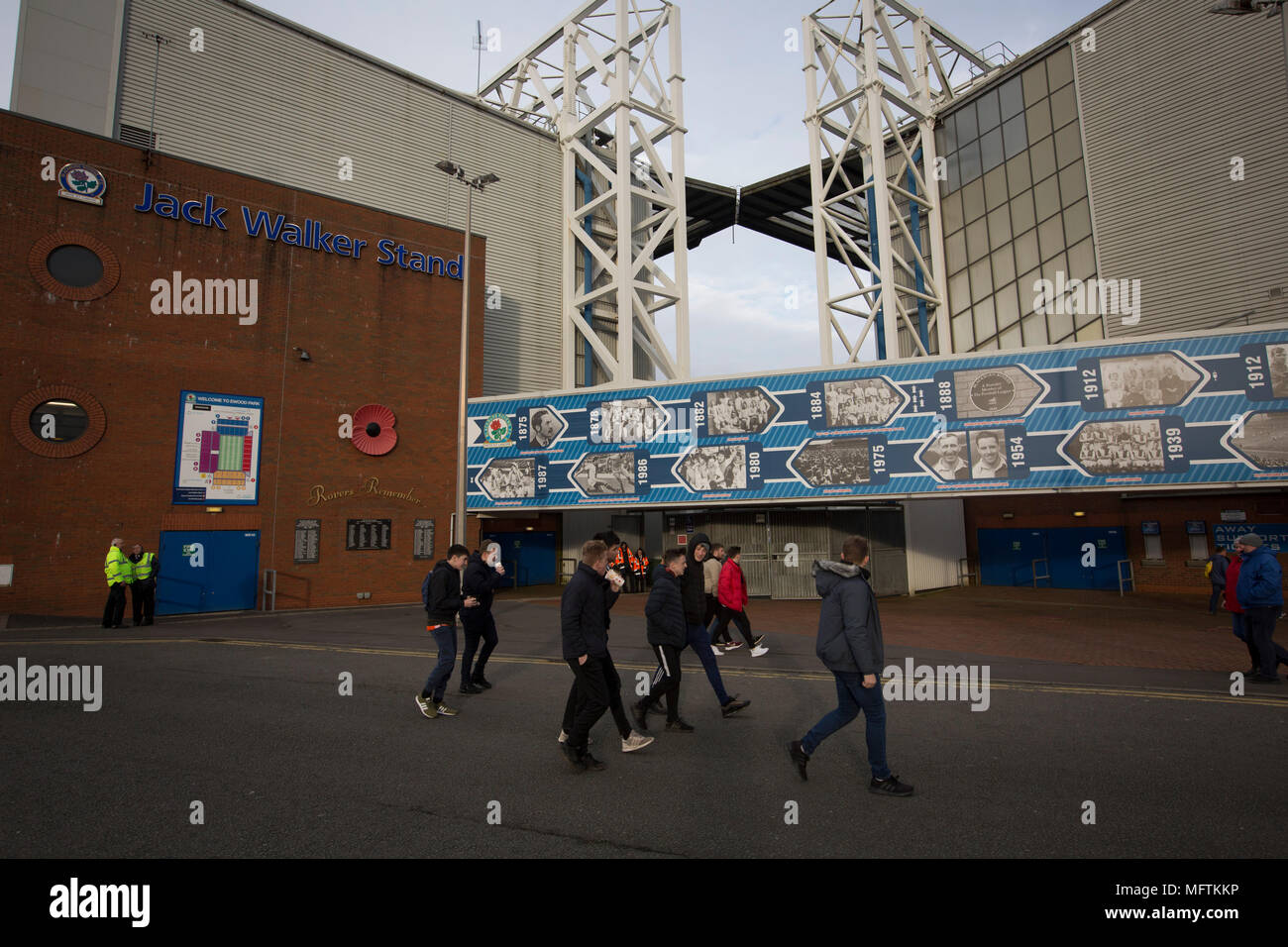 A group of young supporters walking past a display dedicated to the home club's history before Blackburn Rovers played Shrewsbury Town in a Sky Bet League One fixture at Ewood Park. Both team were in the top three in the division at the start of the game. Blackburn won the match by 3 goals to 1, watched by a crowd of 13,579. Stock Photo