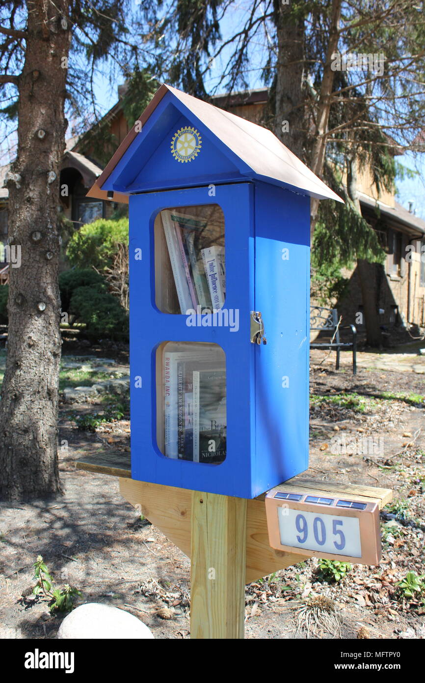 Little free library which gives books away for free to passersby. Stock Photo