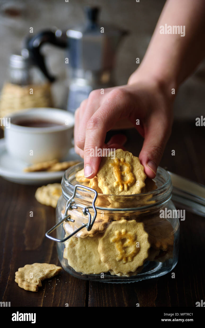 Jar with bitcoin symbol cookies and coffee on background Stock Photo - Alamy