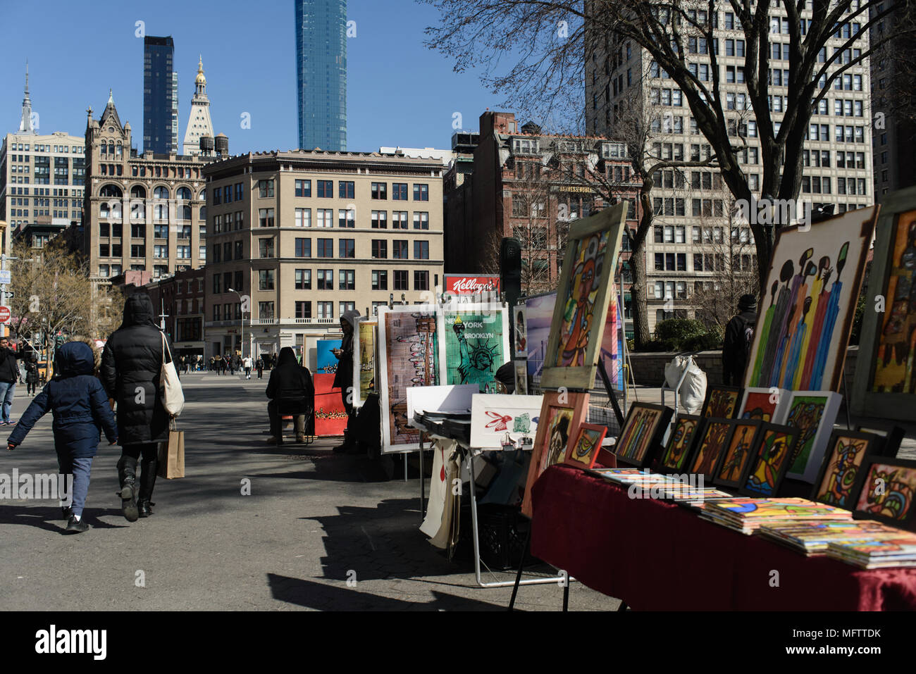 A mother and child walk past stalls selling prints and African art in Union Square. New York, 2018. Stock Photo