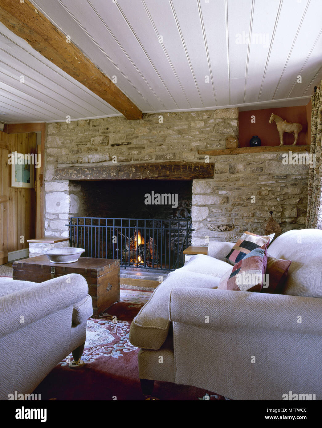 A Rustic Country Style Sitting Room With Beamed Inglenook