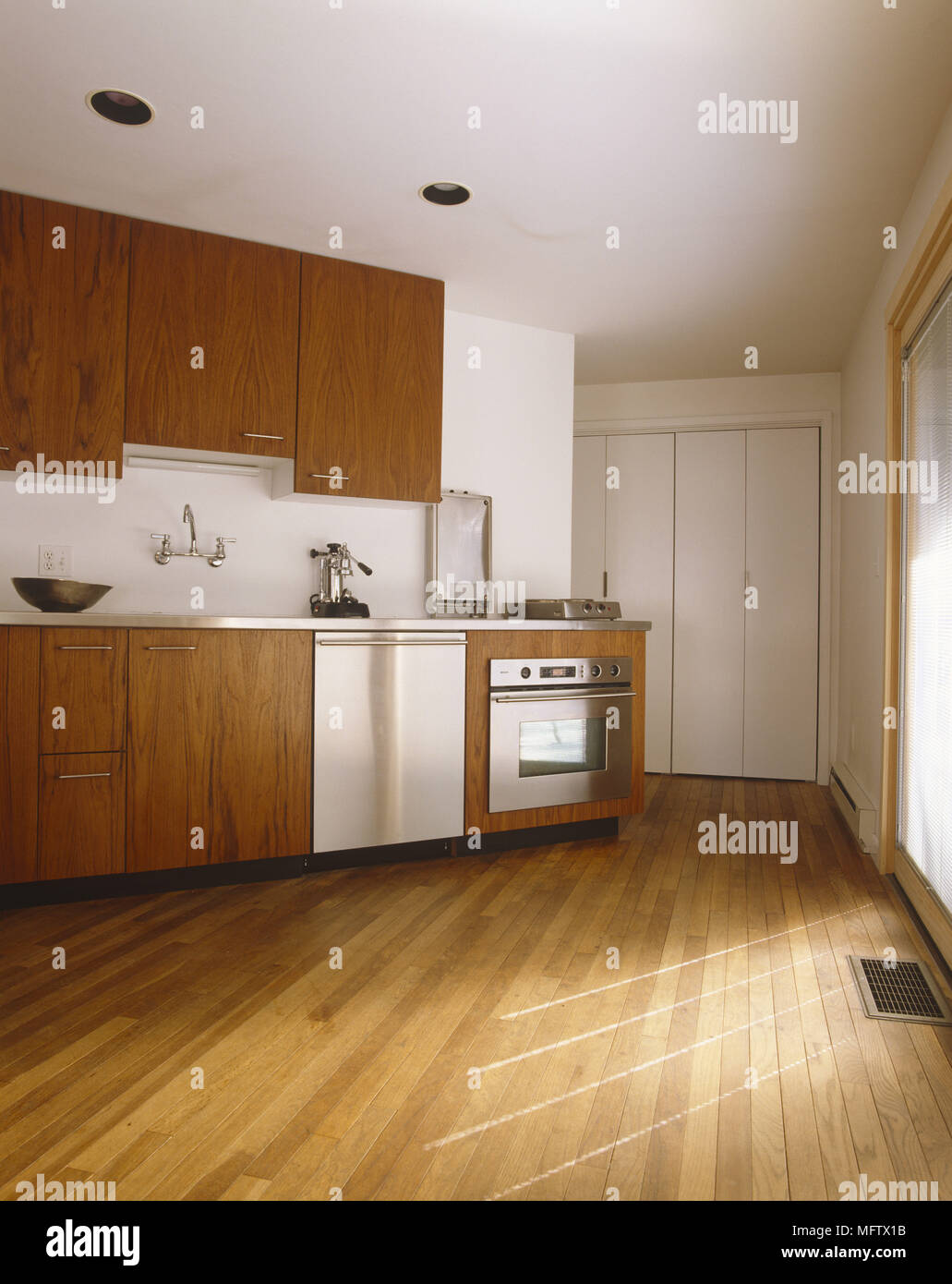Kitchen With Wooden Flooring Wooden Cabinets And Stainless
