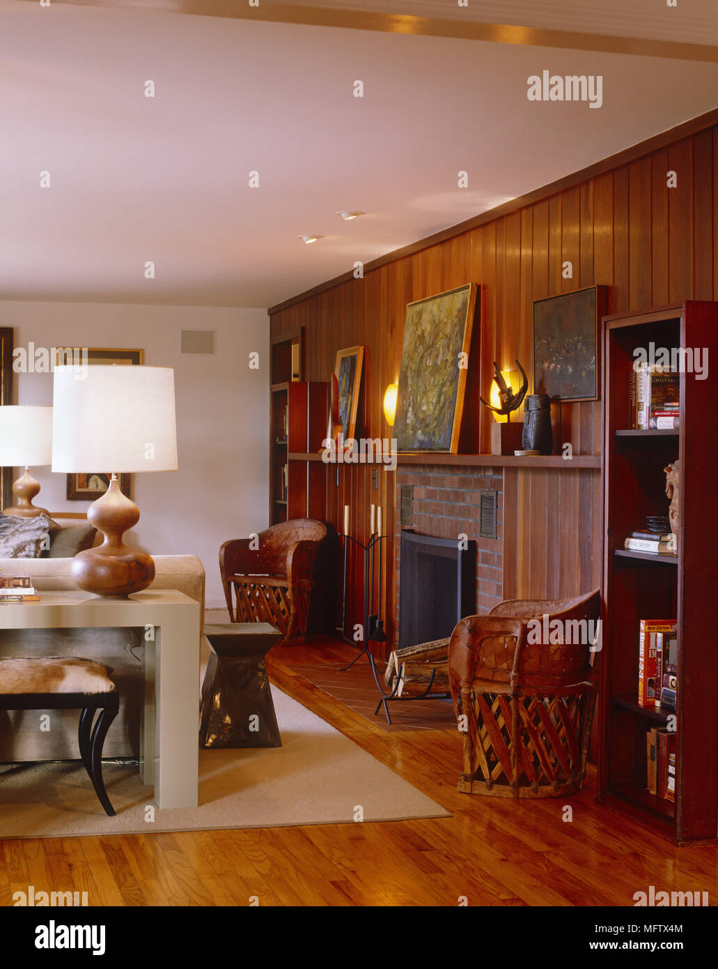 Pair Of Wooden Chairs Either Side Of Fireplace In Modern Country