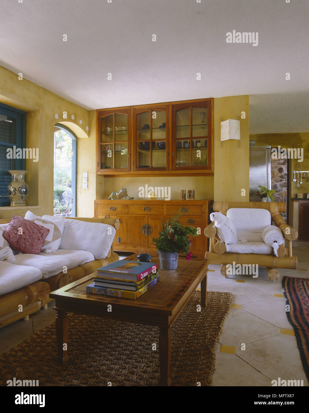 Sitting room with sofa armchair coffee table storage and tiled