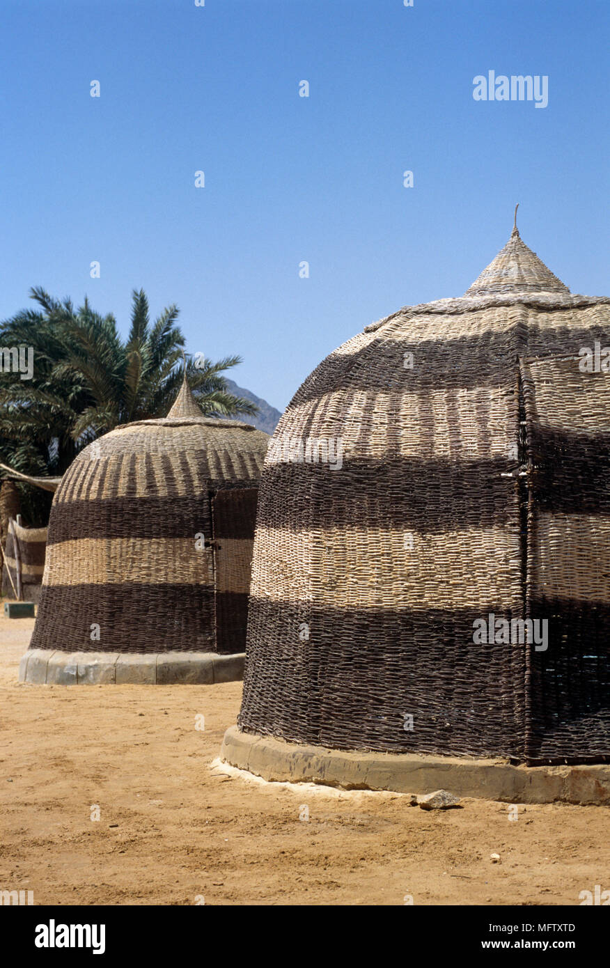 Woven wicker beach huts in Newieba Stock Photo