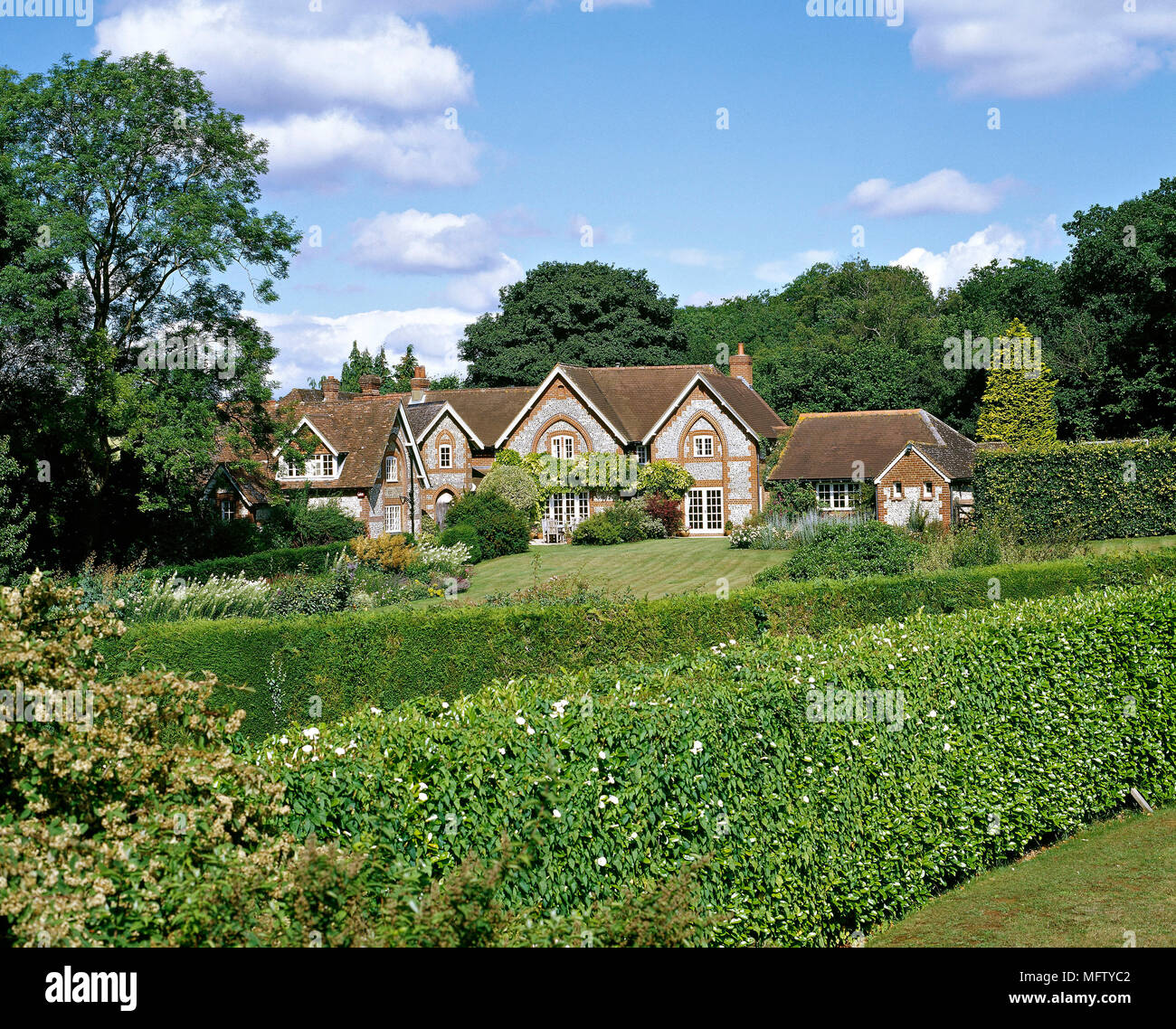 An exterior of a modern, detached country house, garden with hedging Stock Photo
