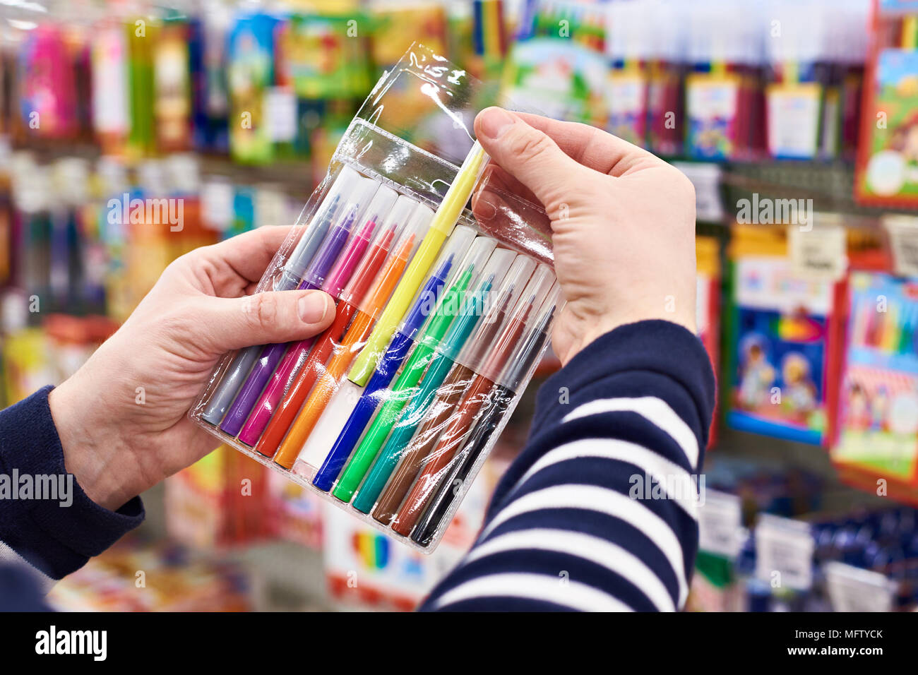 Buyer selects felt pens in the stationery store Stock Photo