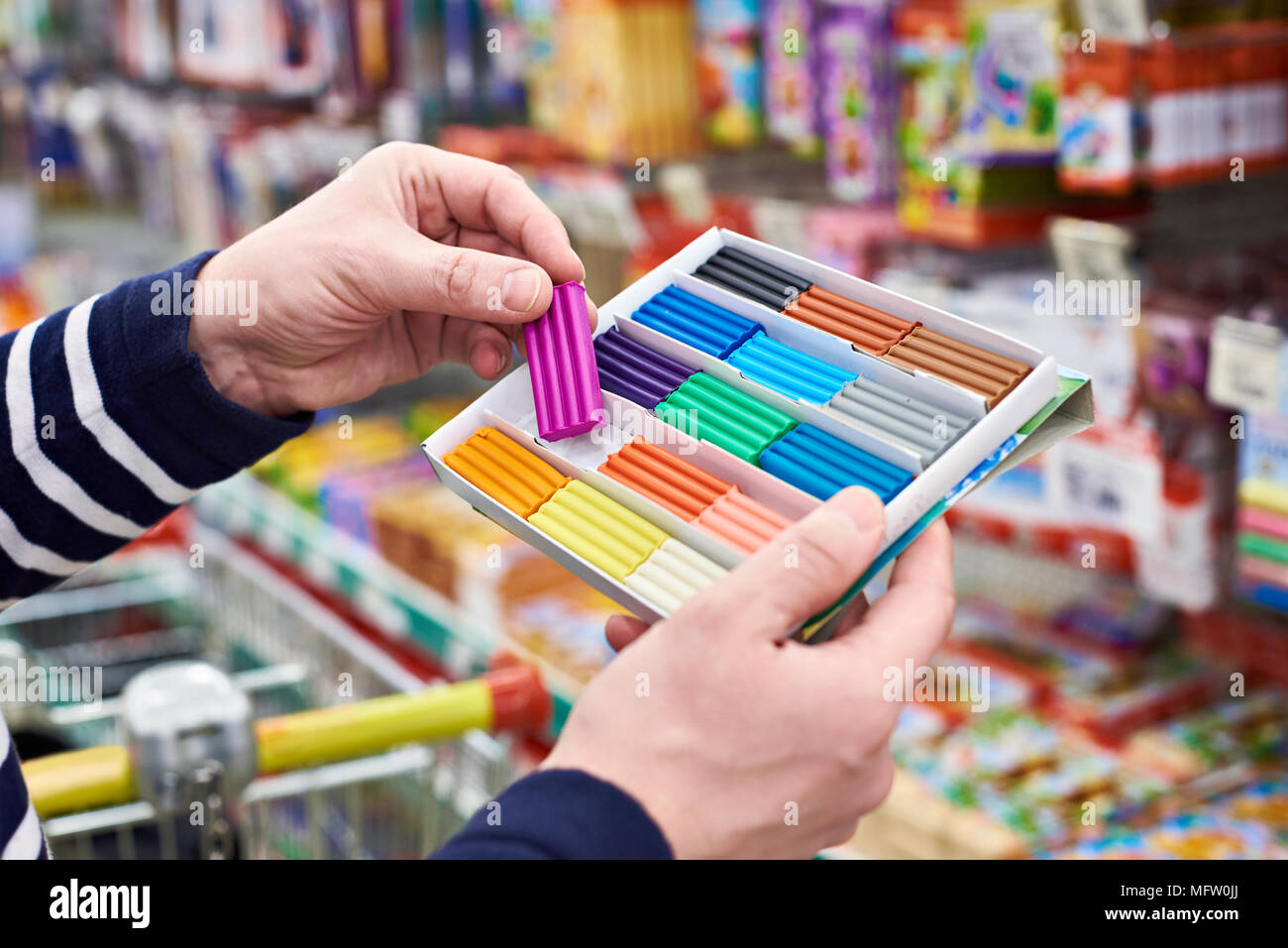 Buyer chooses plasticine in the stationery store Stock Photo