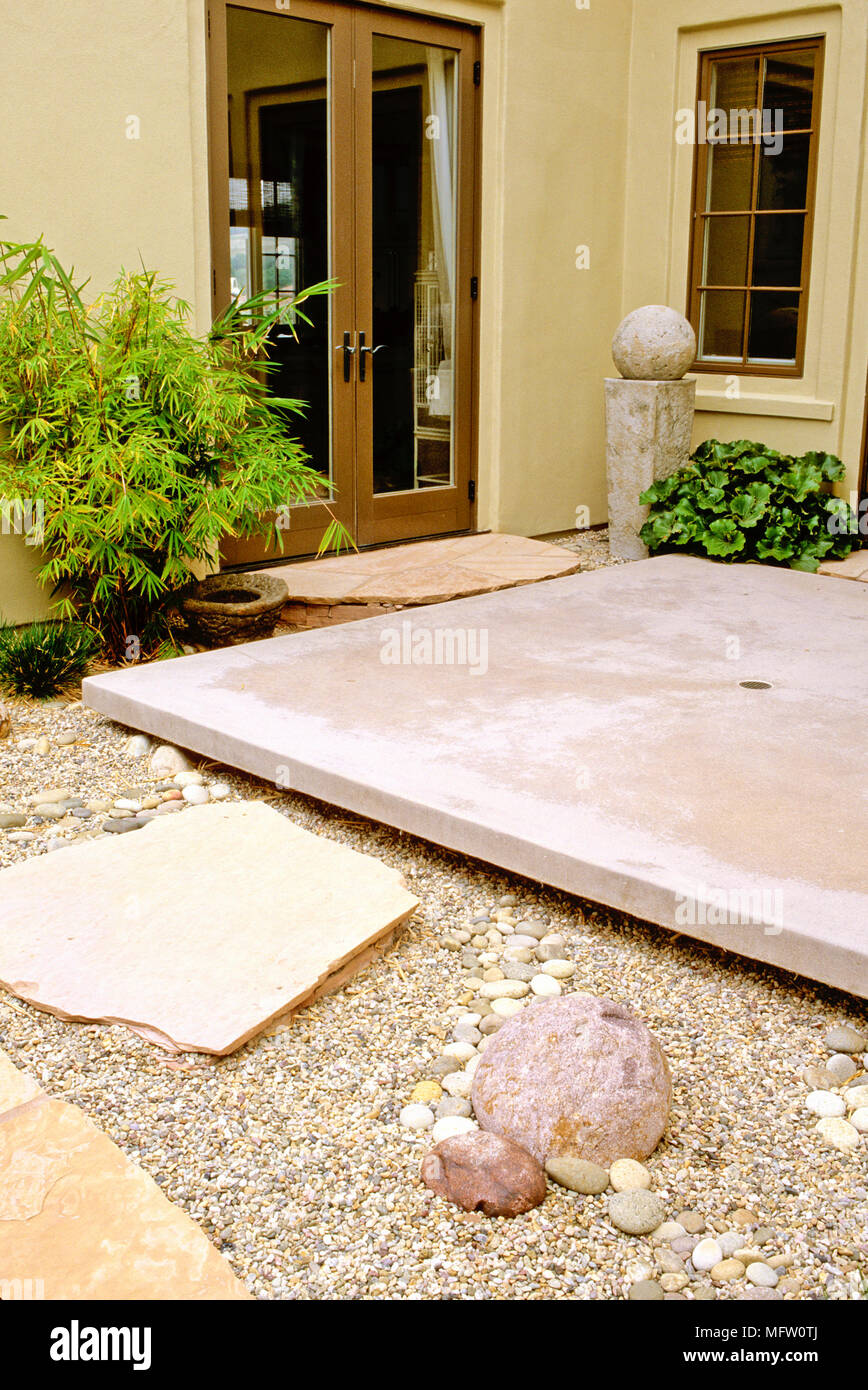 Contemporary stone patio over gravel garden Stock Photo Alamy