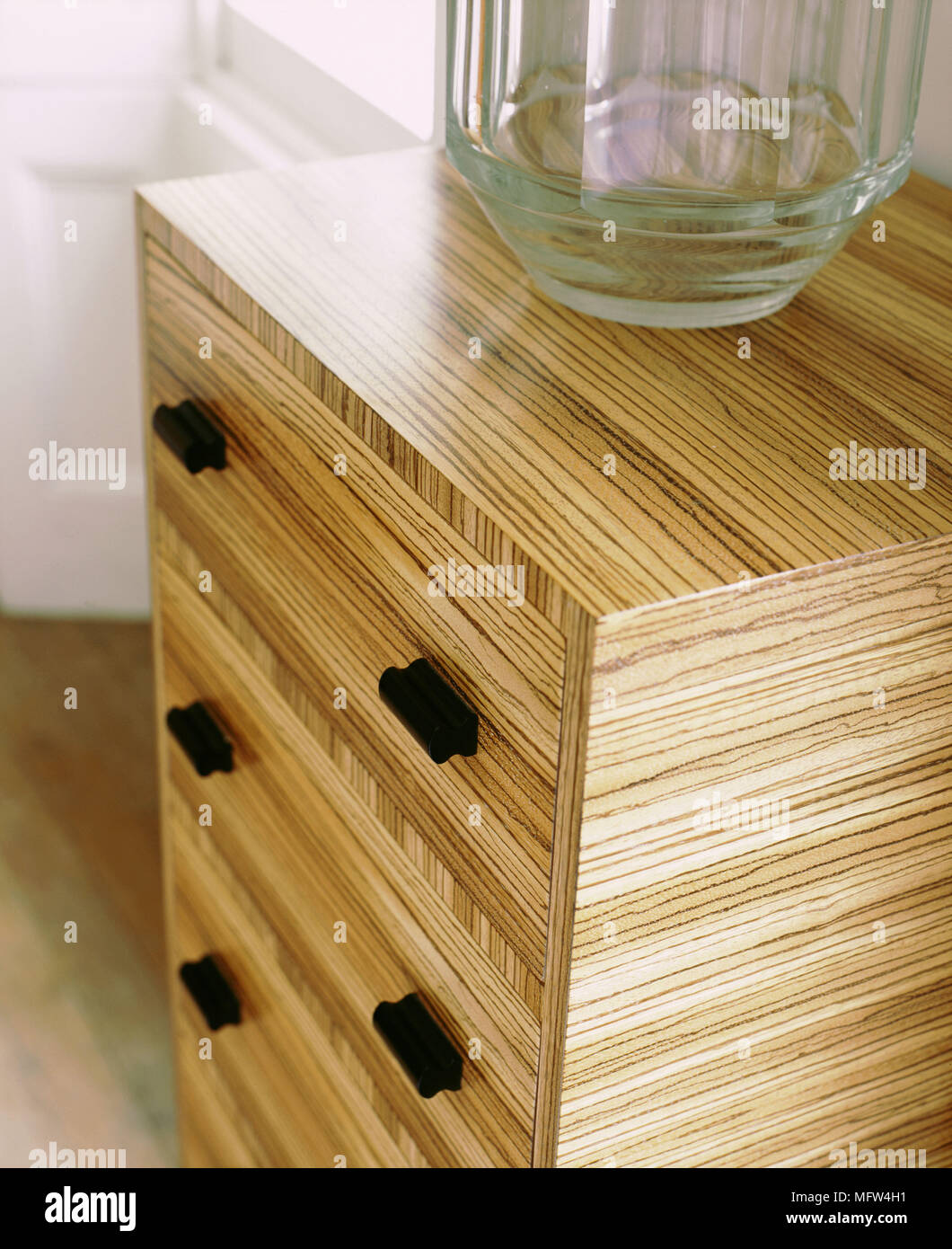 Detail Of A Wood Laminate Dresser With Black Drawer Pulls Stock