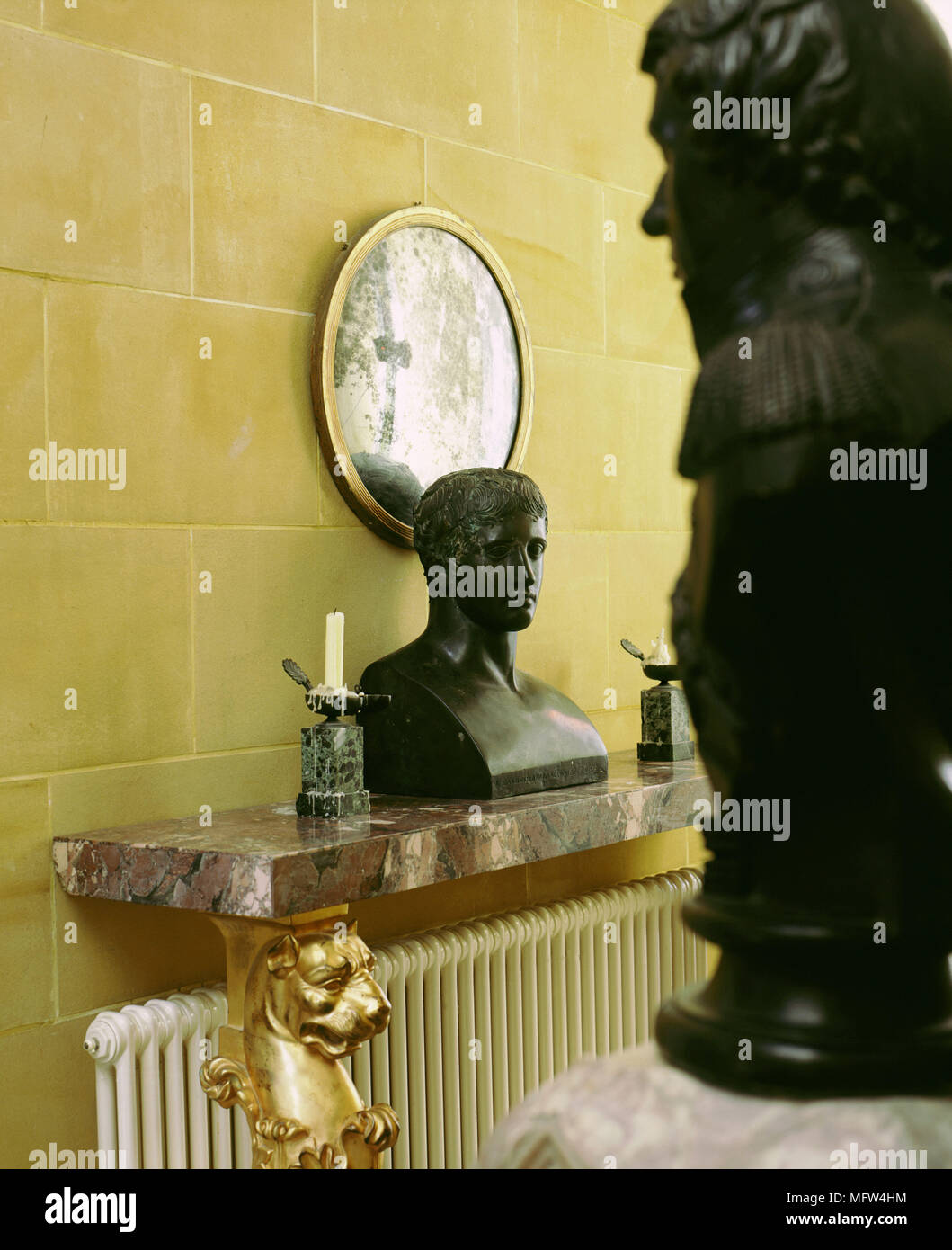 Detail of sculpture on a marble wall shelf with gilt supports. Stock Photo