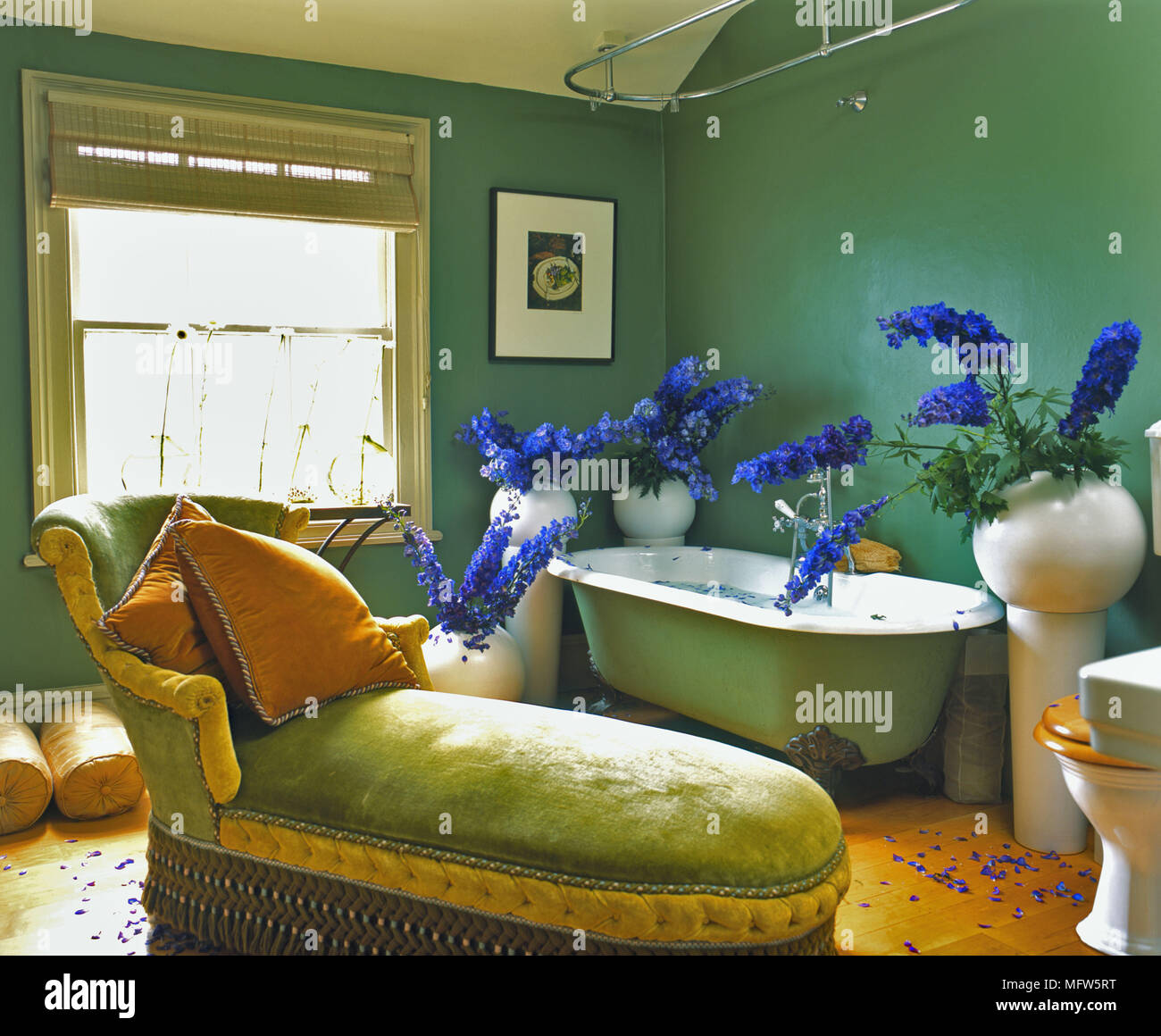 A traditional green bathroom freestanding roll top bath upholstered ...