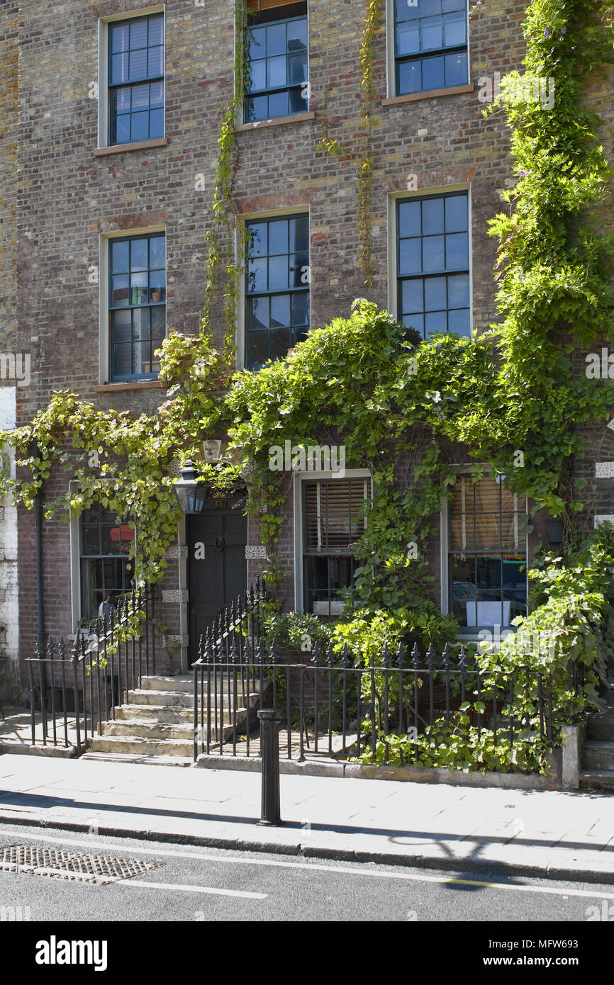 The exterior of a terraced house with metal railings next to steps ... The exterior of a terraced house with metal railings next to steps ...