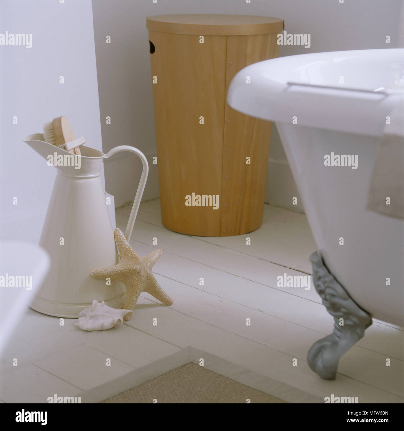 A detail of a neutral country bathroom with painted floorboards a