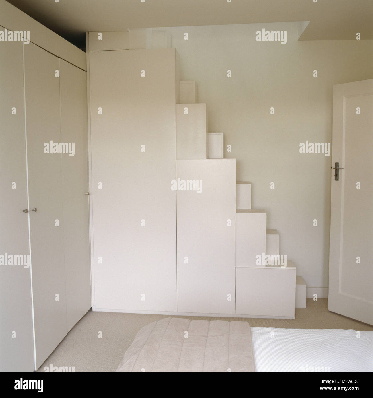 A Detail Of A White Minimalist Bedroom With Fitted Wardrobes Block