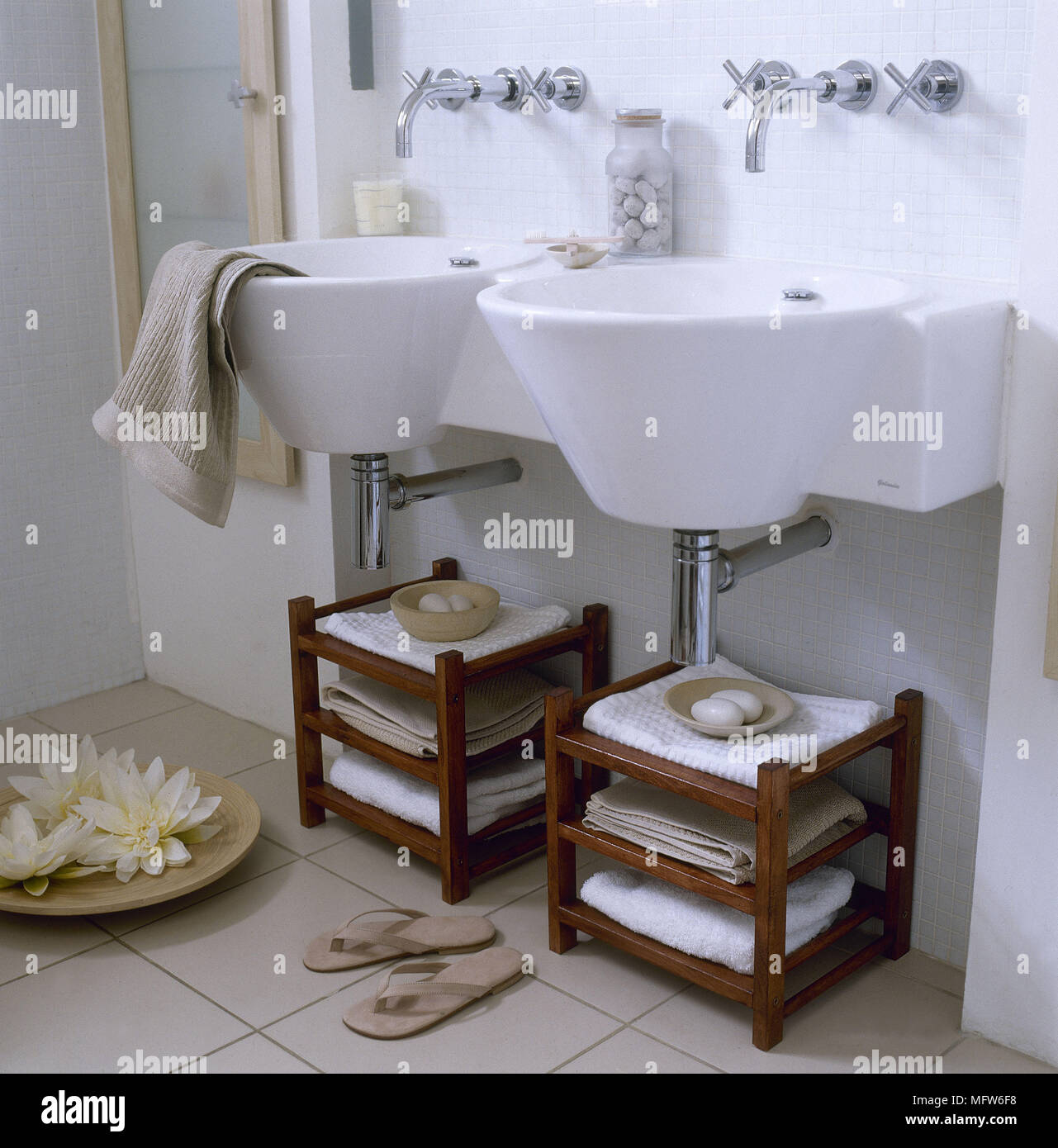 https://c8.alamy.com/comp/MFW6F8/a-modern-bathroom-with-twin-wall-mounted-wash-basins-wood-storage-shelf-units-tiled-floor-MFW6F8.jpg