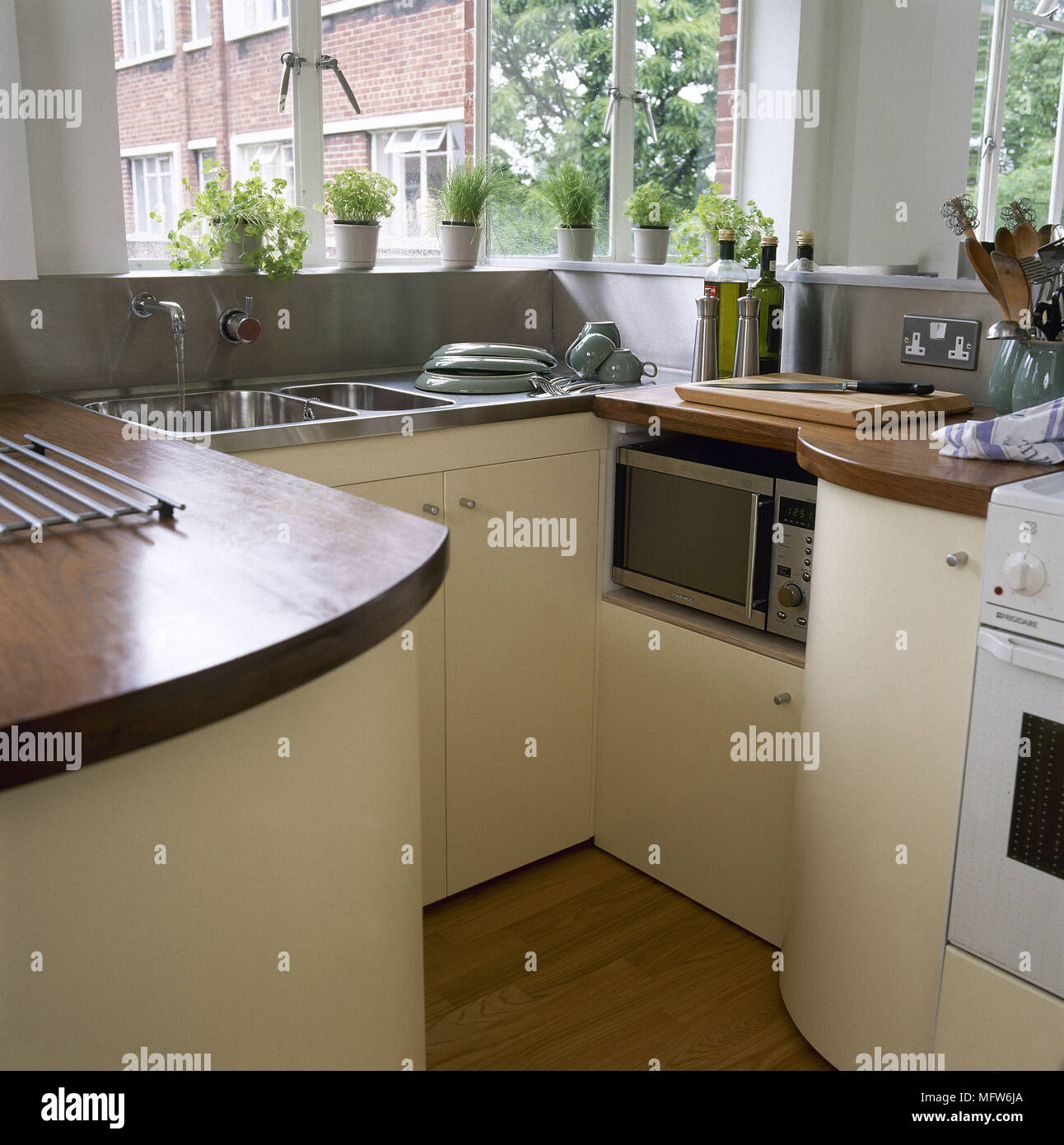 Download Kitchen With Yellow Units And Wooden Work Tops With Stainless Steel Sink Stock Photo Alamy Yellowimages Mockups