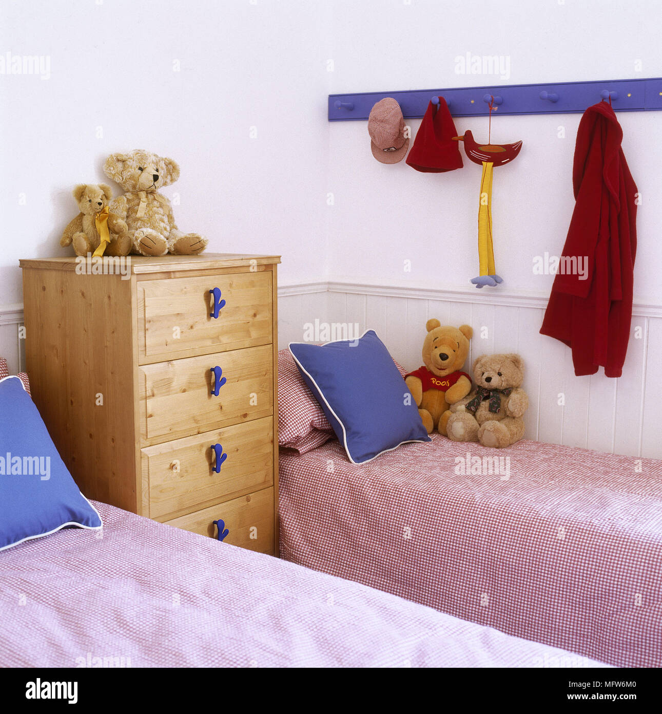 Pair Of Single Beds And Pine Chest Of Drawers In Child S Bedroom