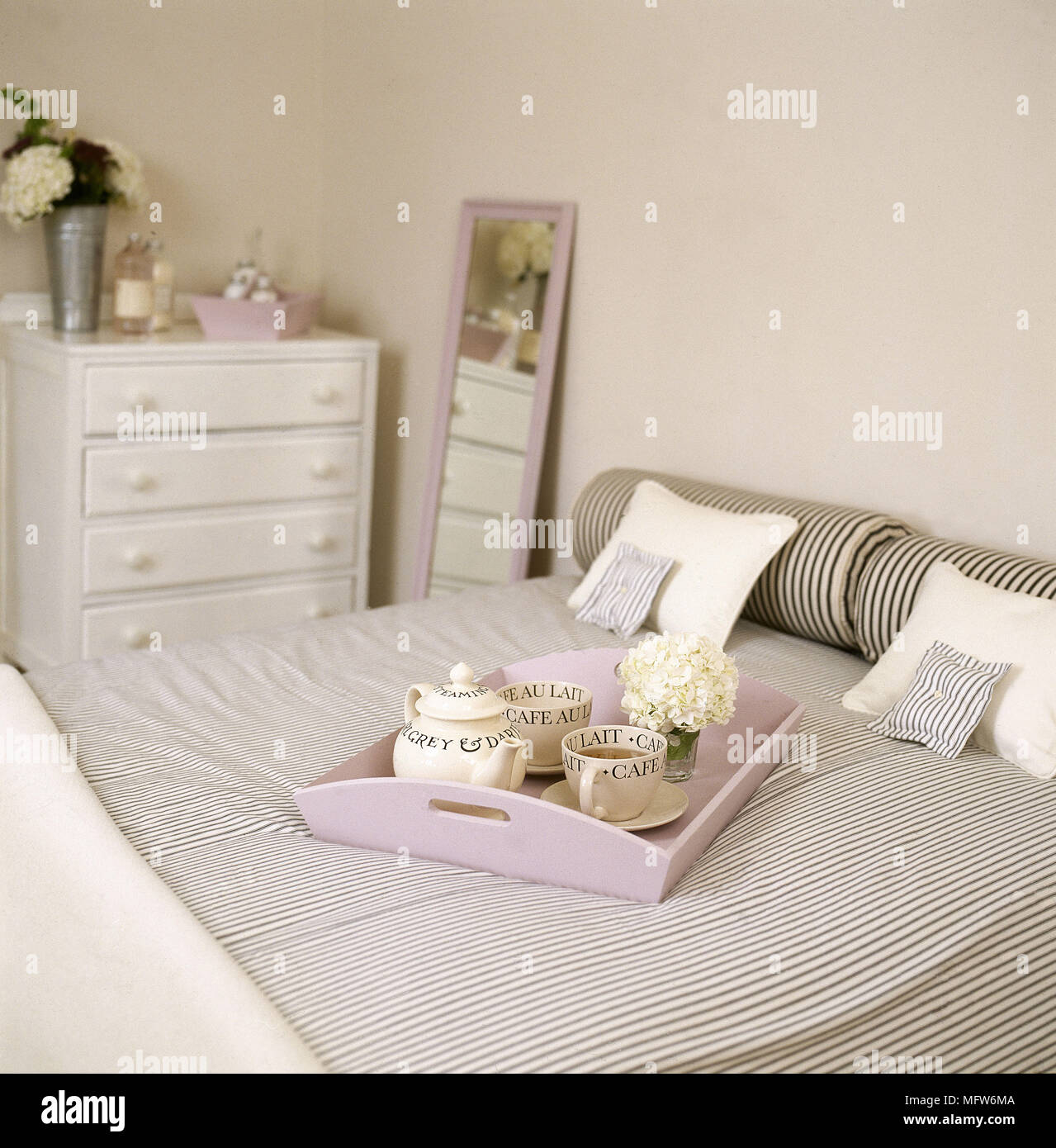 Pink Breakfast Tray On Bed With Striped Bed Linen Chest Of Drawers