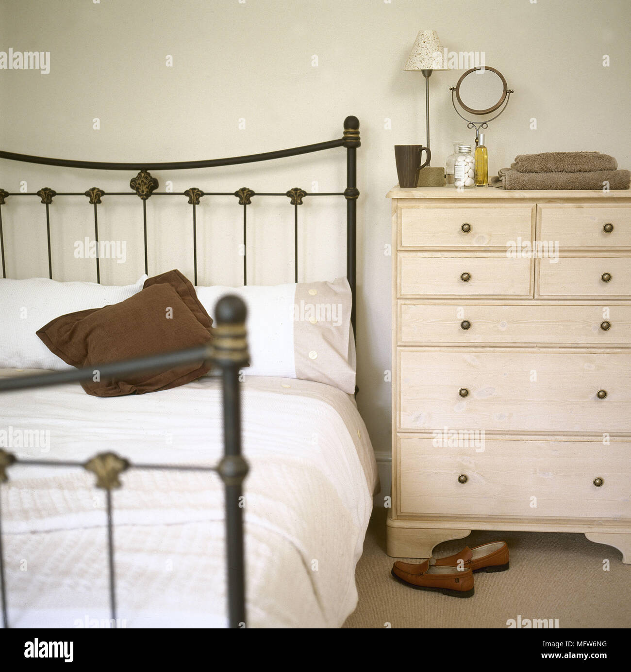 Wrought Iron Bed And Chest Of Drawers In Bedroom Stock Photo