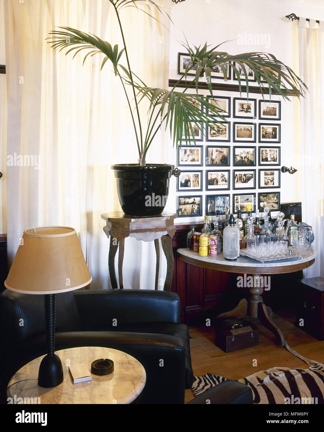 Traditional sitting room detail with leather armchair, drinks table ...