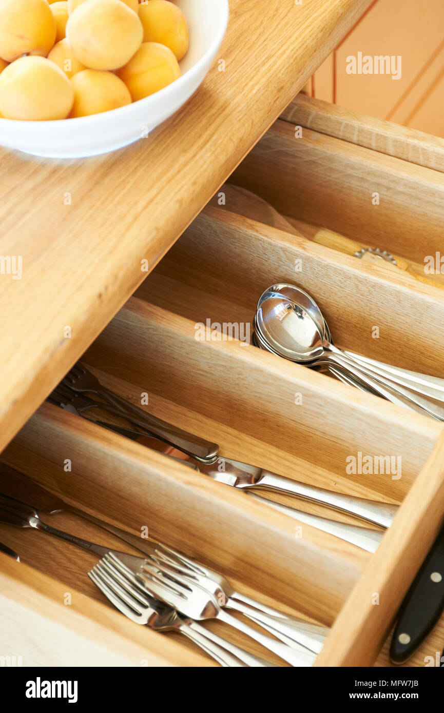 Open cutlery drawer with knives, forks and spoons Stock Photo Alamy