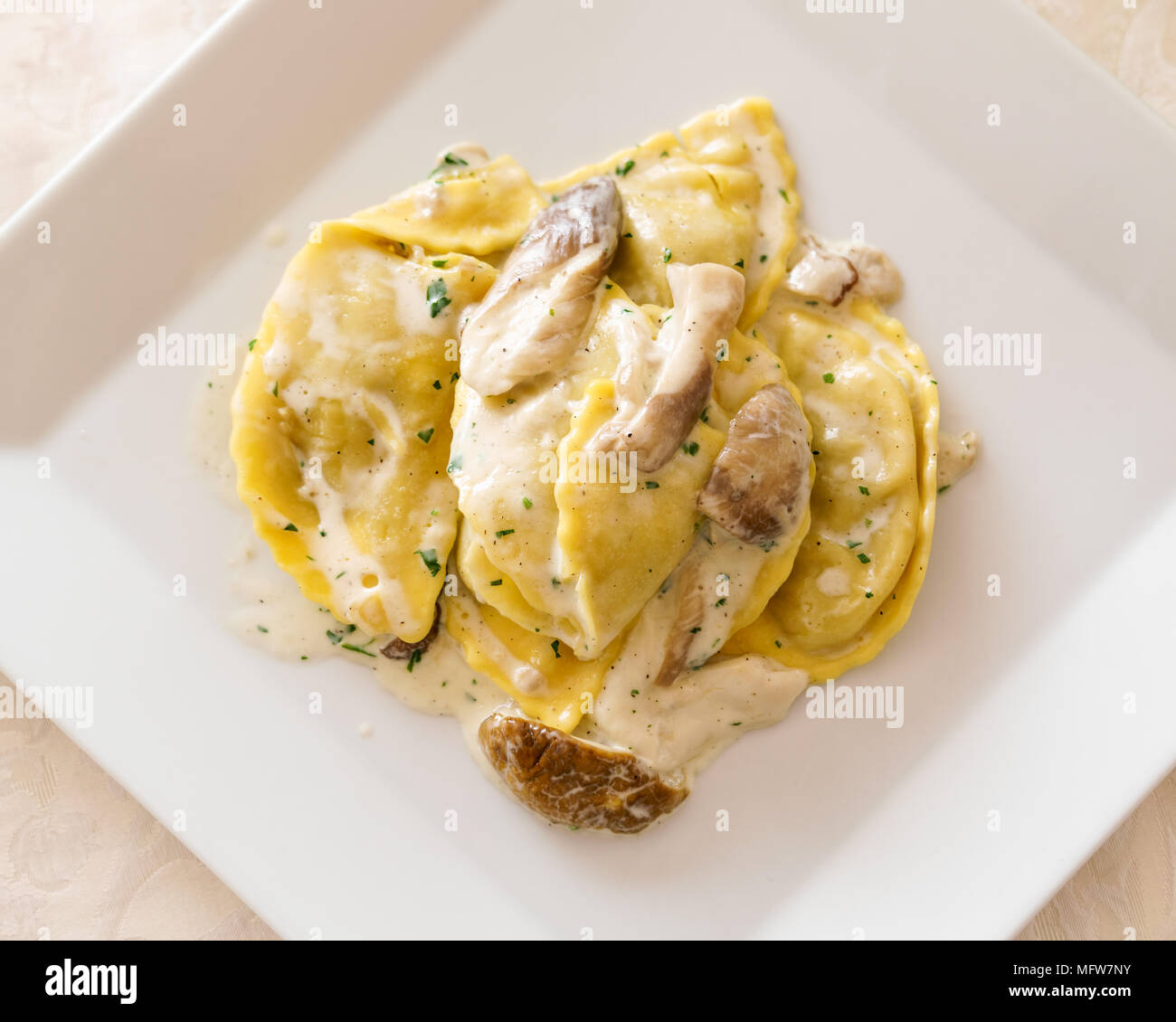 Italian ravioli tortellini with Porcini mushrooms, cream sauce, parsley.view from above Stock