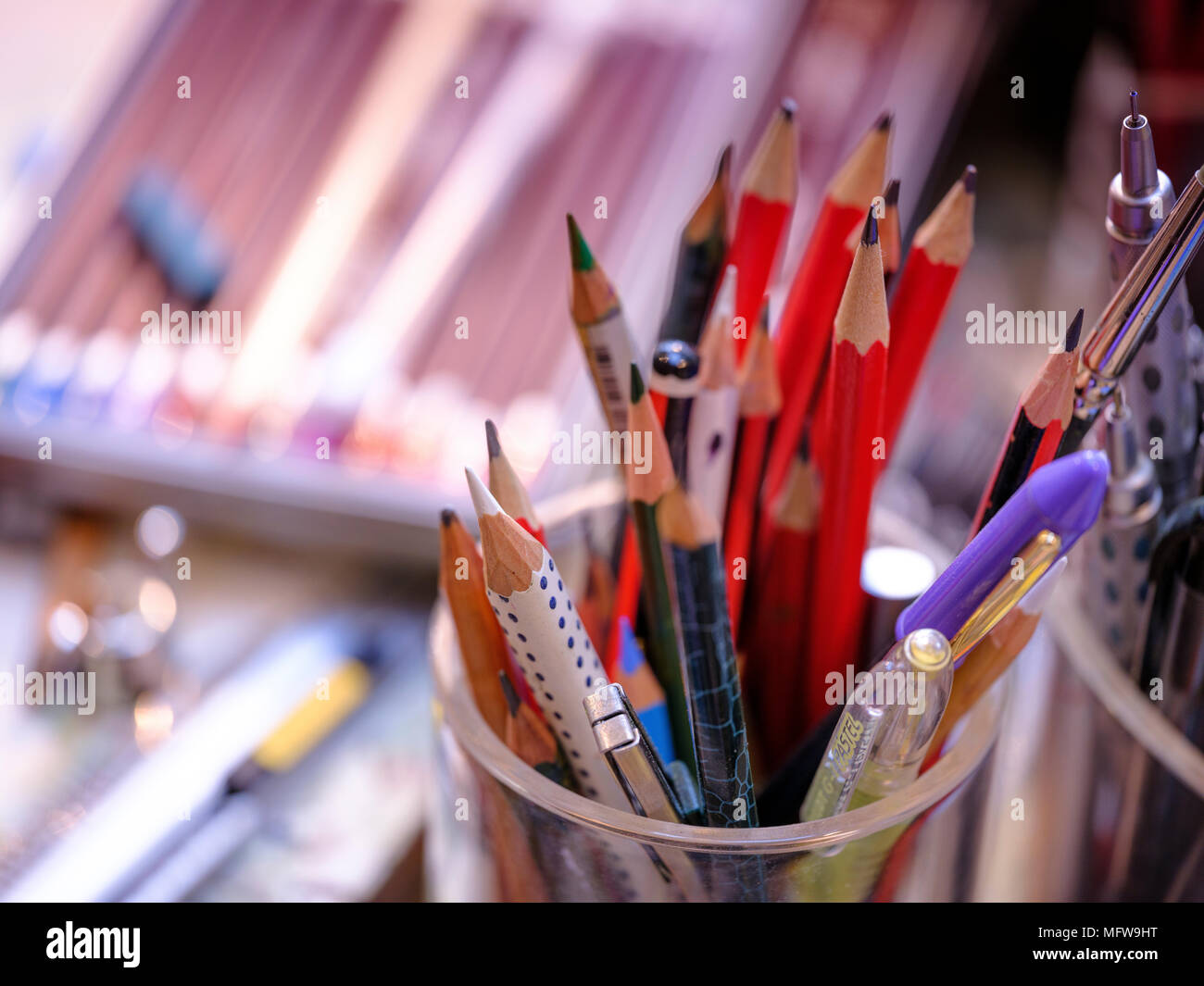 Artist pencils in a jar on a studio desk. Stock Photo