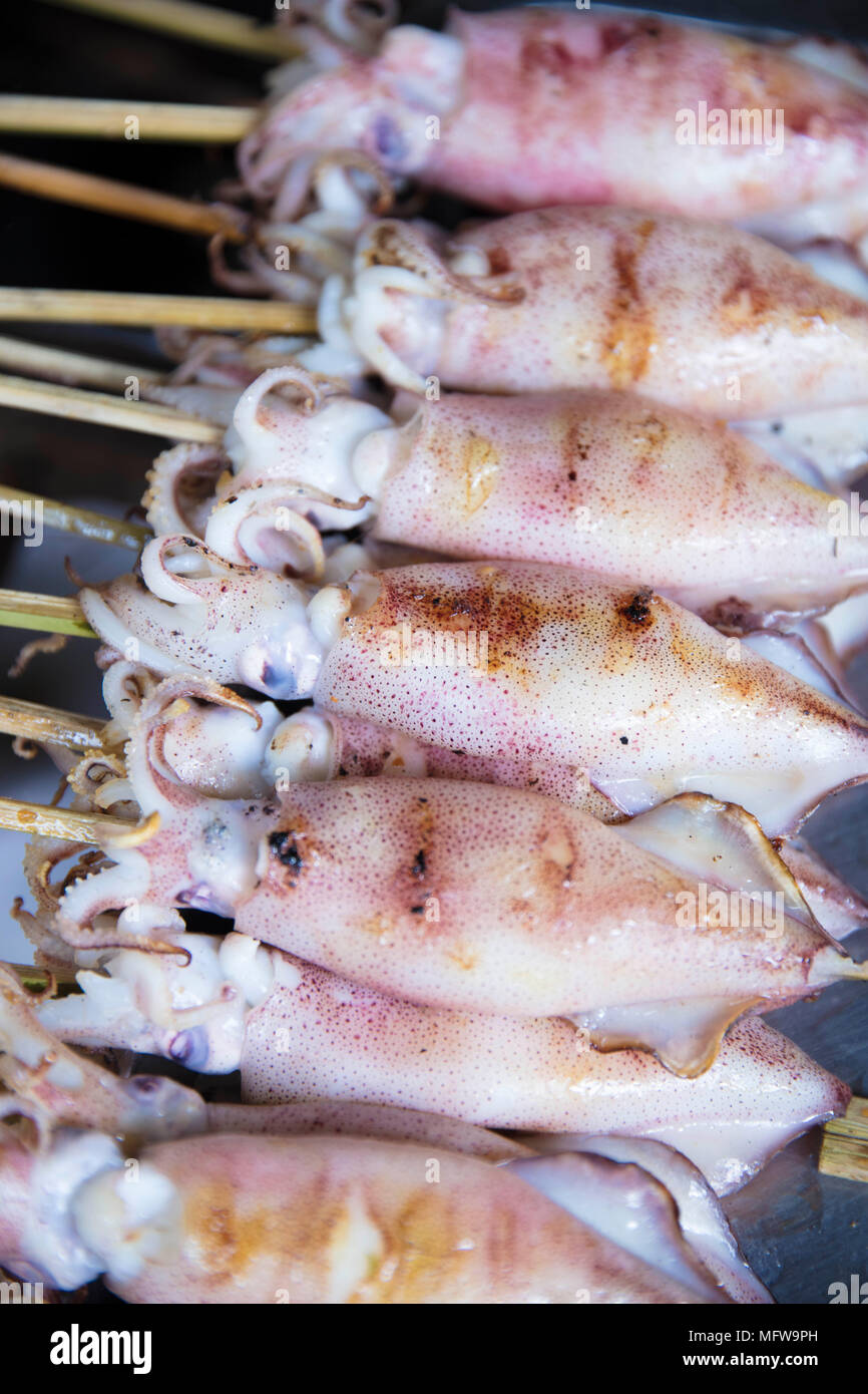 Baby squid barbecuing at a stall in the Crab market in Kep village, Cambodia Stock Photo