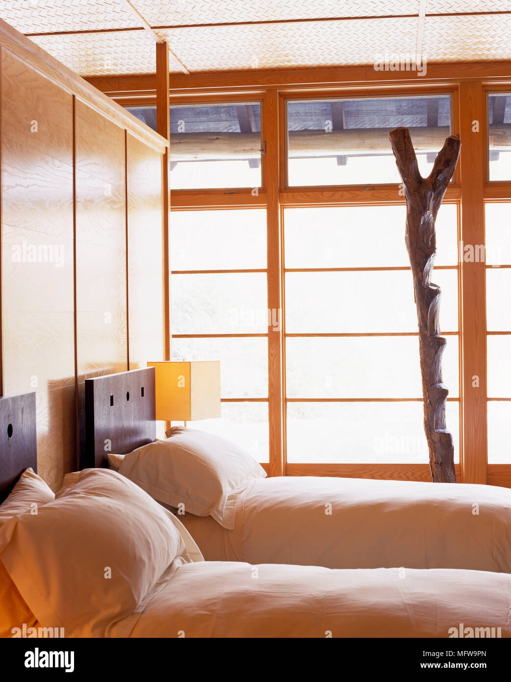 Bedroom with twin beds in front of wooden panel Stock Photo