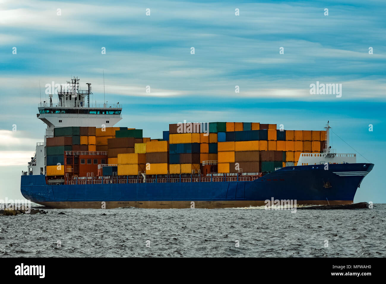 Blue container ship fully loaded moving from the sea Stock Photo - Alamy