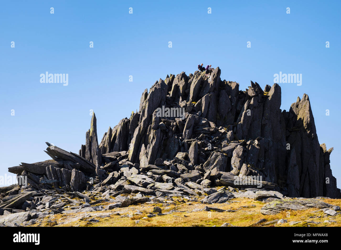 Castell y Gwynt on Glyder Fach mountain with hikers scrambling down the rocks in Snowdonia National Park. Wales, UK, Britain Stock Photo