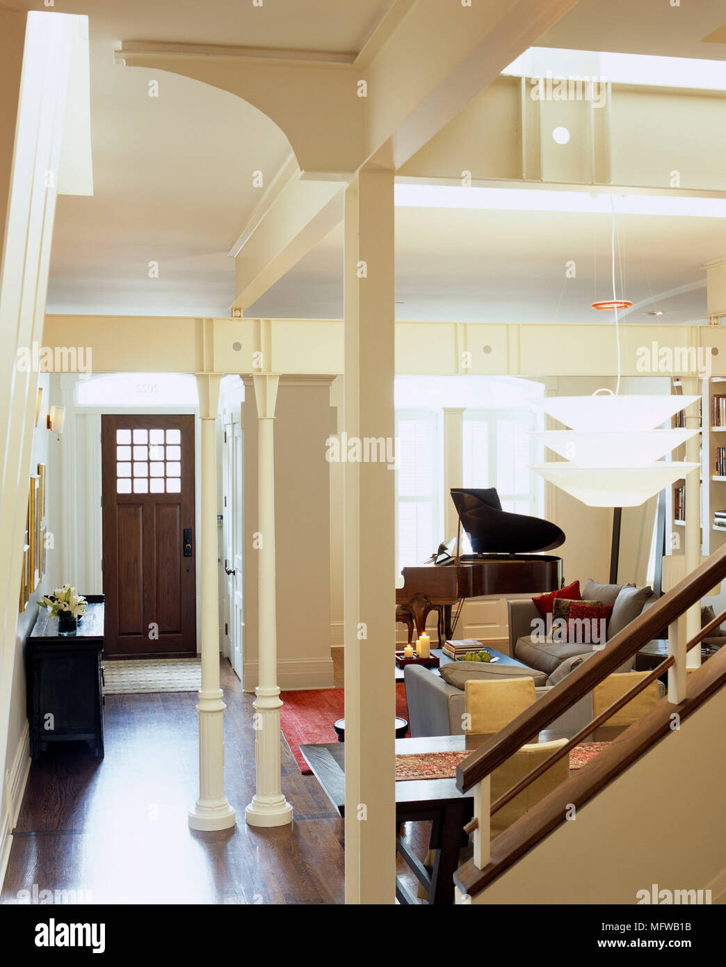 Open Plan Room With Front Door Entrance Leading Into Sitting