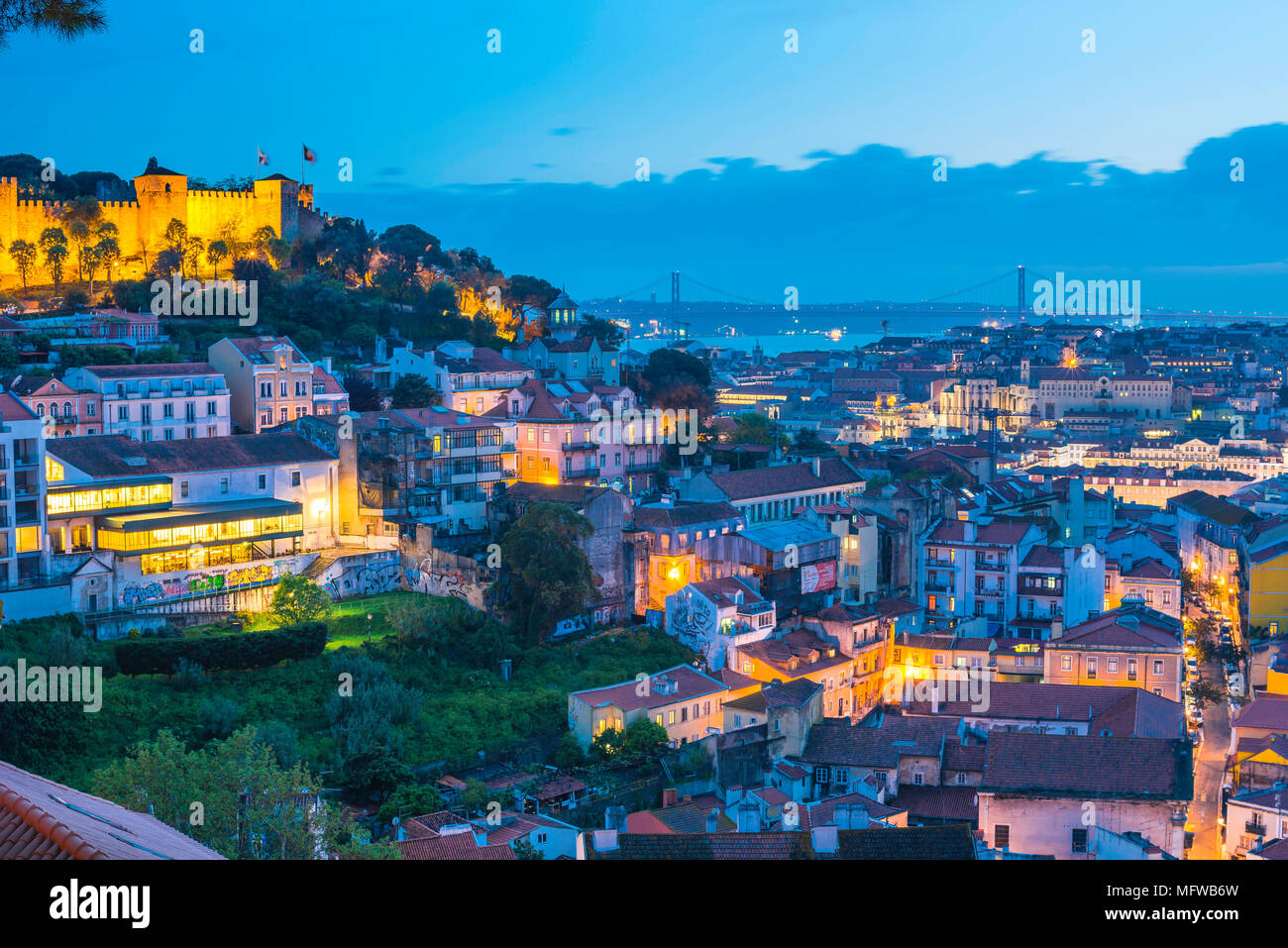 Lisbon Portugal city, view at night across the rooftops of the old town Mouraria area towards the center of the city of Lisbon, Portugal. Stock Photo