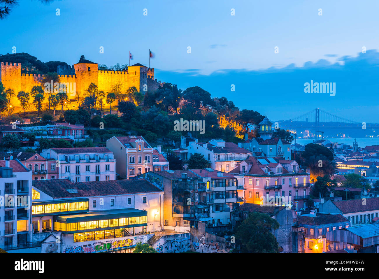 Portugal travel city, view at night across the rooftops of the colorful old town Mouraria area towards the Rio Tejo in the center of Lisbon, Portugal Stock Photo