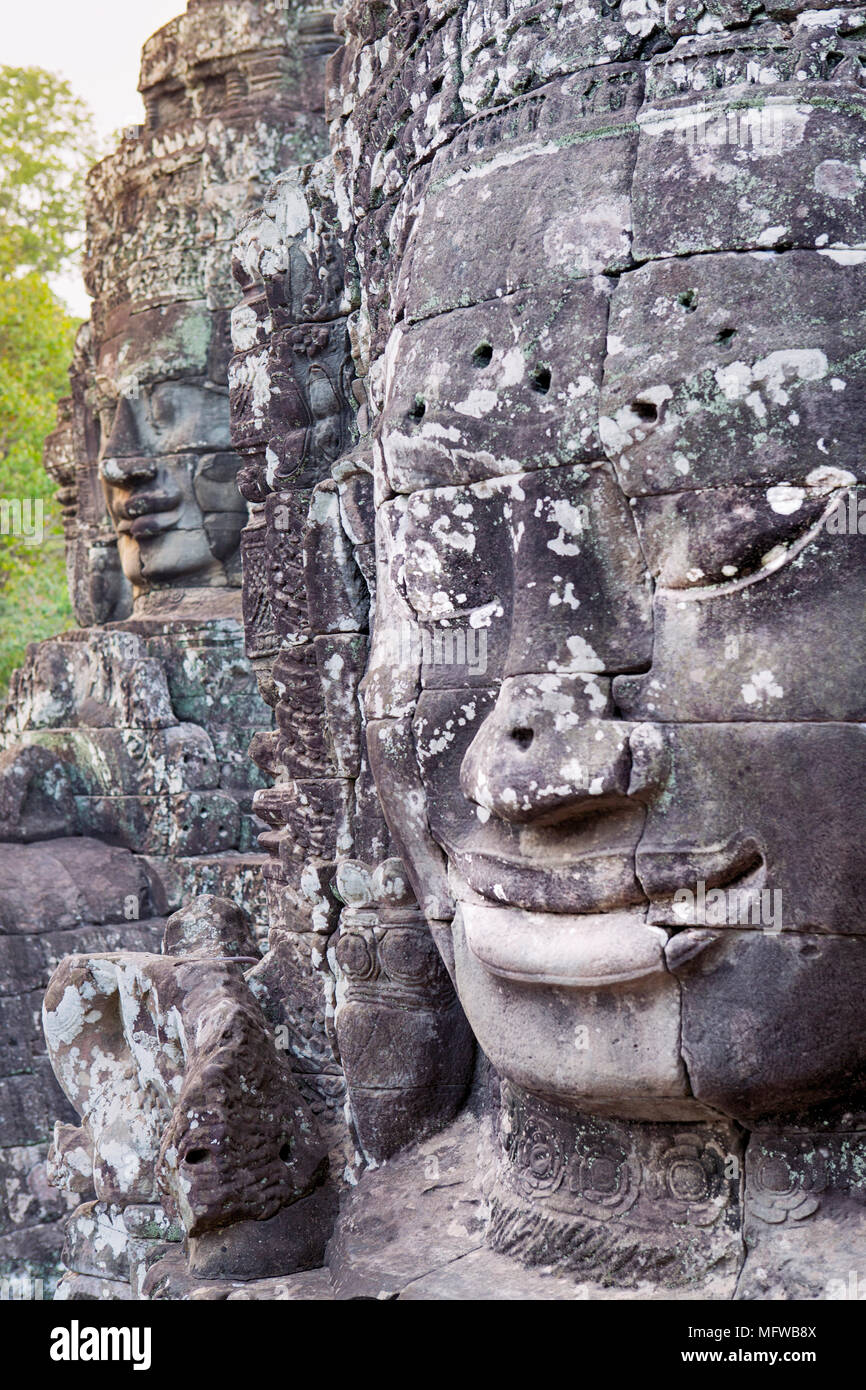 Smiling Buddha face at the Bayon temple in Angkor, Cambodia, shot on a sunny day Stock Photo