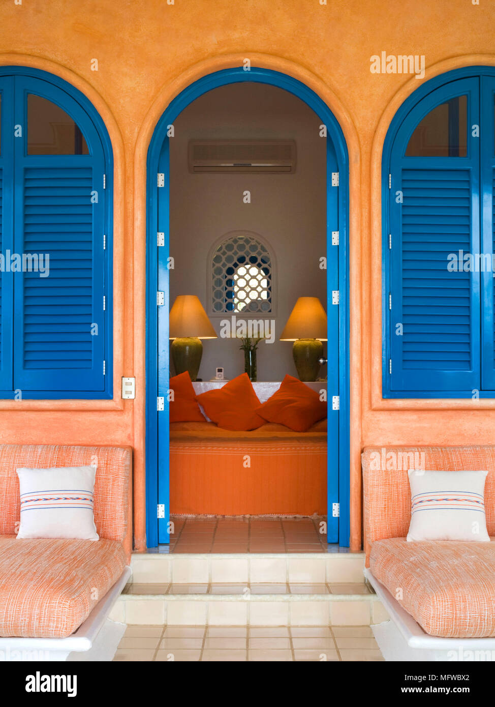 Hand-painted decoration on double doors in traditional with rush-seated  ladder-back chair and terracotta tiled floor Stock Photo - Alamy