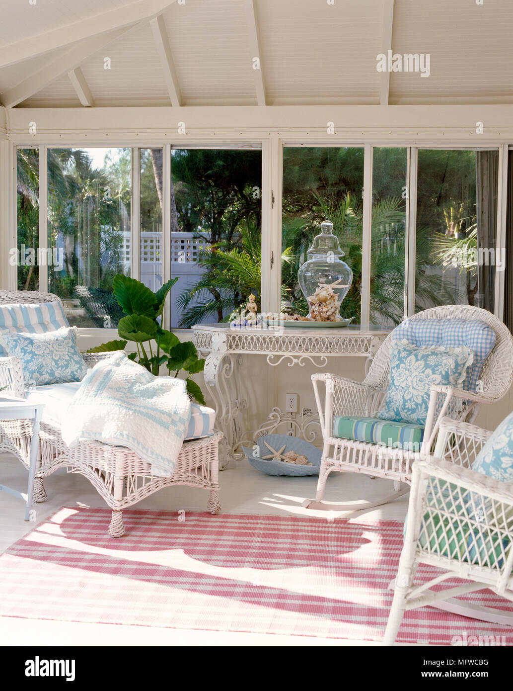 White cane furniture in country style conservatory Stock Photo - Alamy