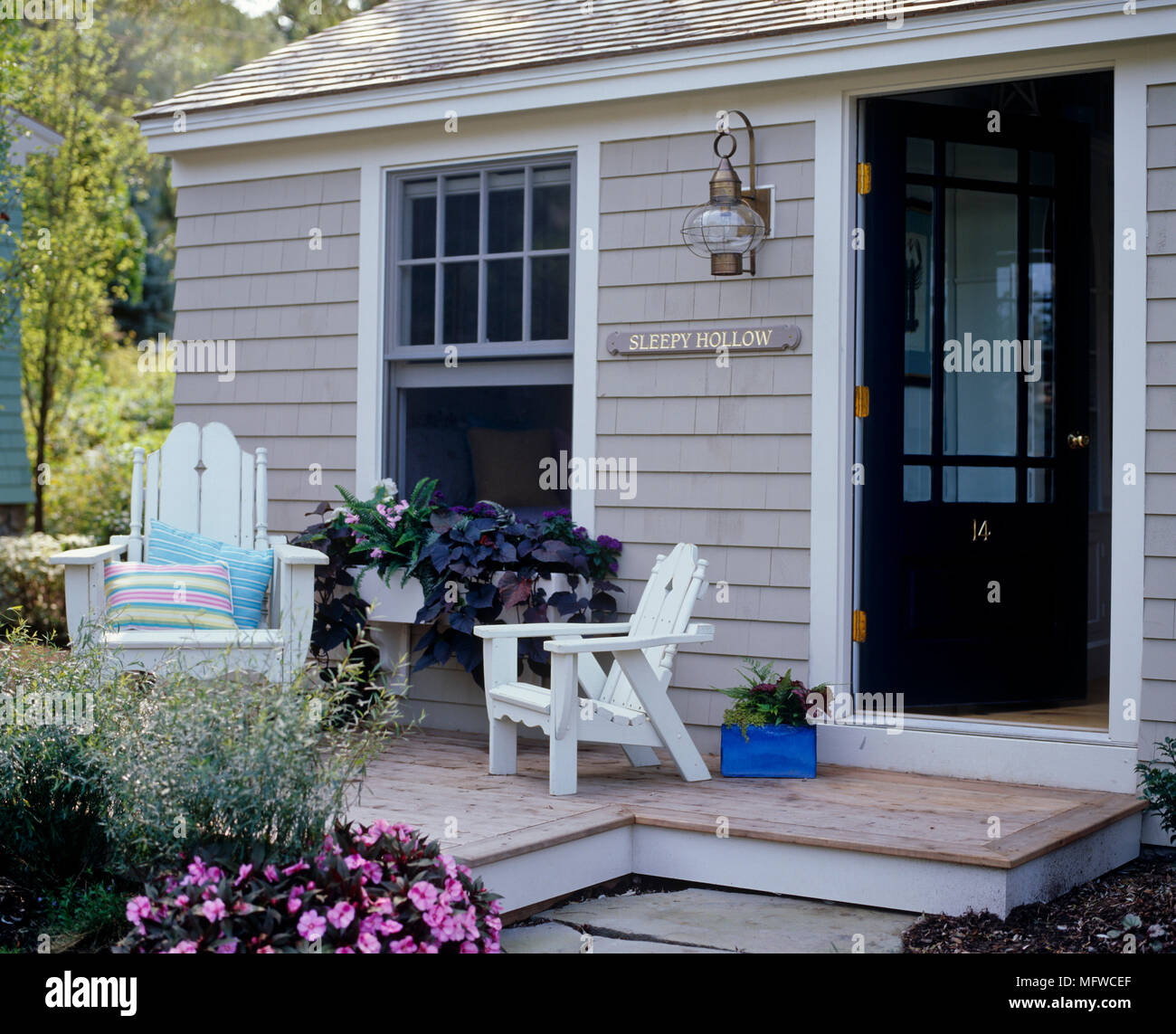 Adirondack chairs on patio outside country style house Stock Photo Alamy