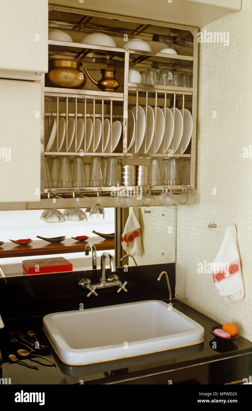 Tableware stored in rack above sink set in shelf unit Stock Photo Alamy